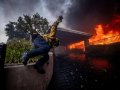 Thousands flee as wildfires burn out of control in and around Los Angeles and homes are destroyed